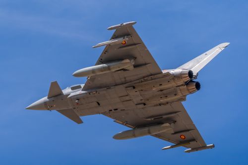 Free An impressive Eurofighter jet soars in clear skies over Castilla-La Mancha, España. Stock Photo