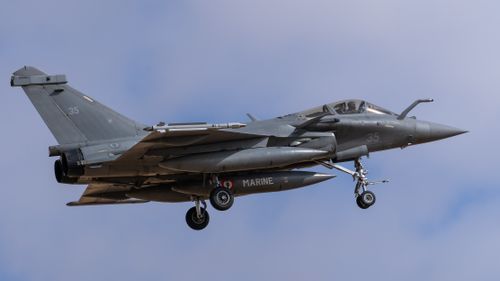 Free Dassault Rafale jet flying over Los Llanos, Spain, showcasing military aviation prowess. Stock Photo