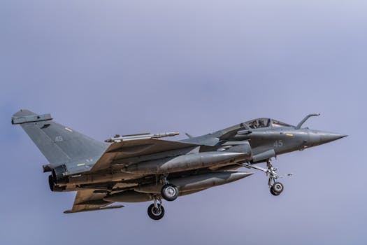 A Dassault Rafale jet captured in mid-air against a clear sky at Los Llanos, Spain.