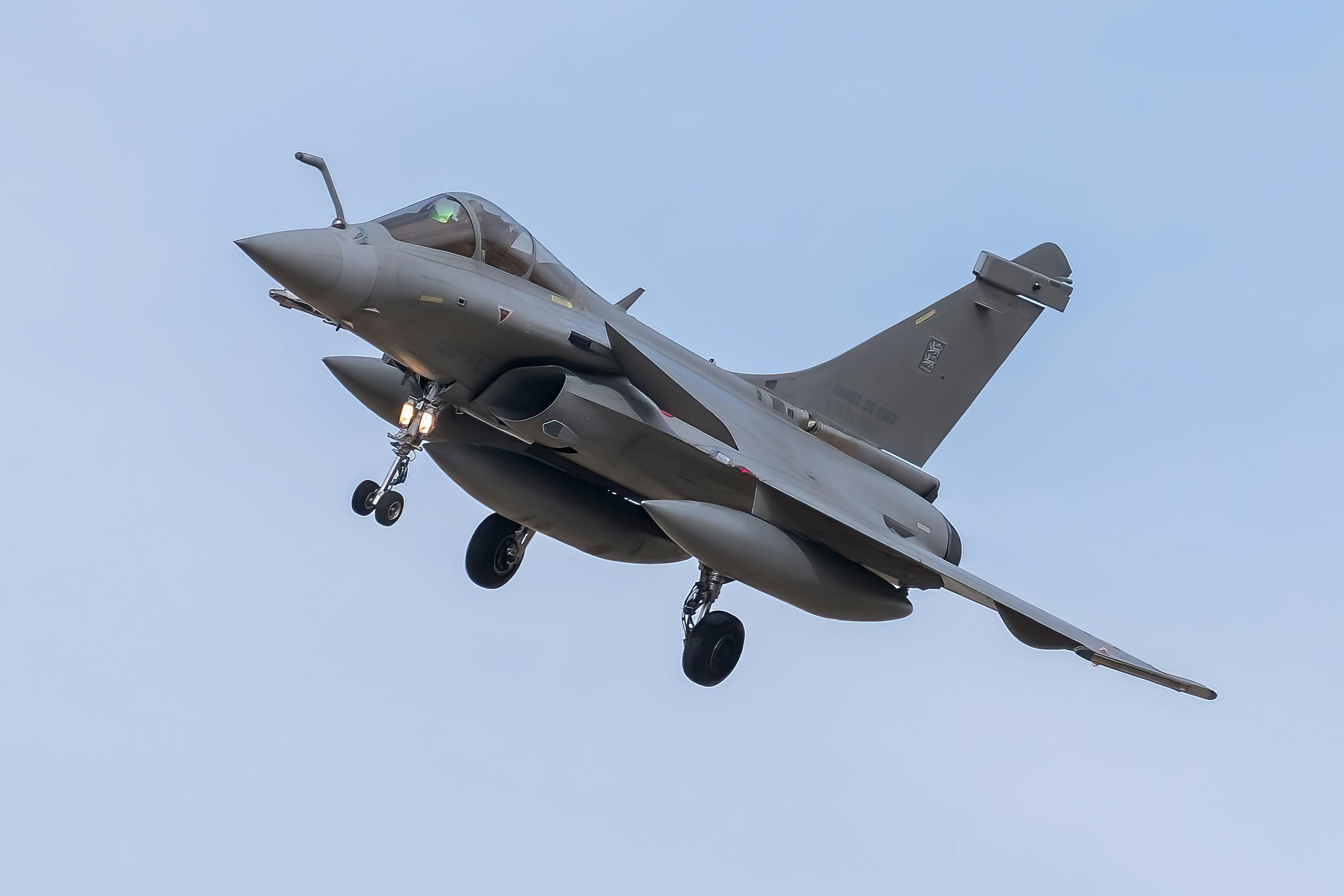 A Dassault Rafale jet in mid-flight against a clear blue sky at Los Llanos Airbase, Spain.