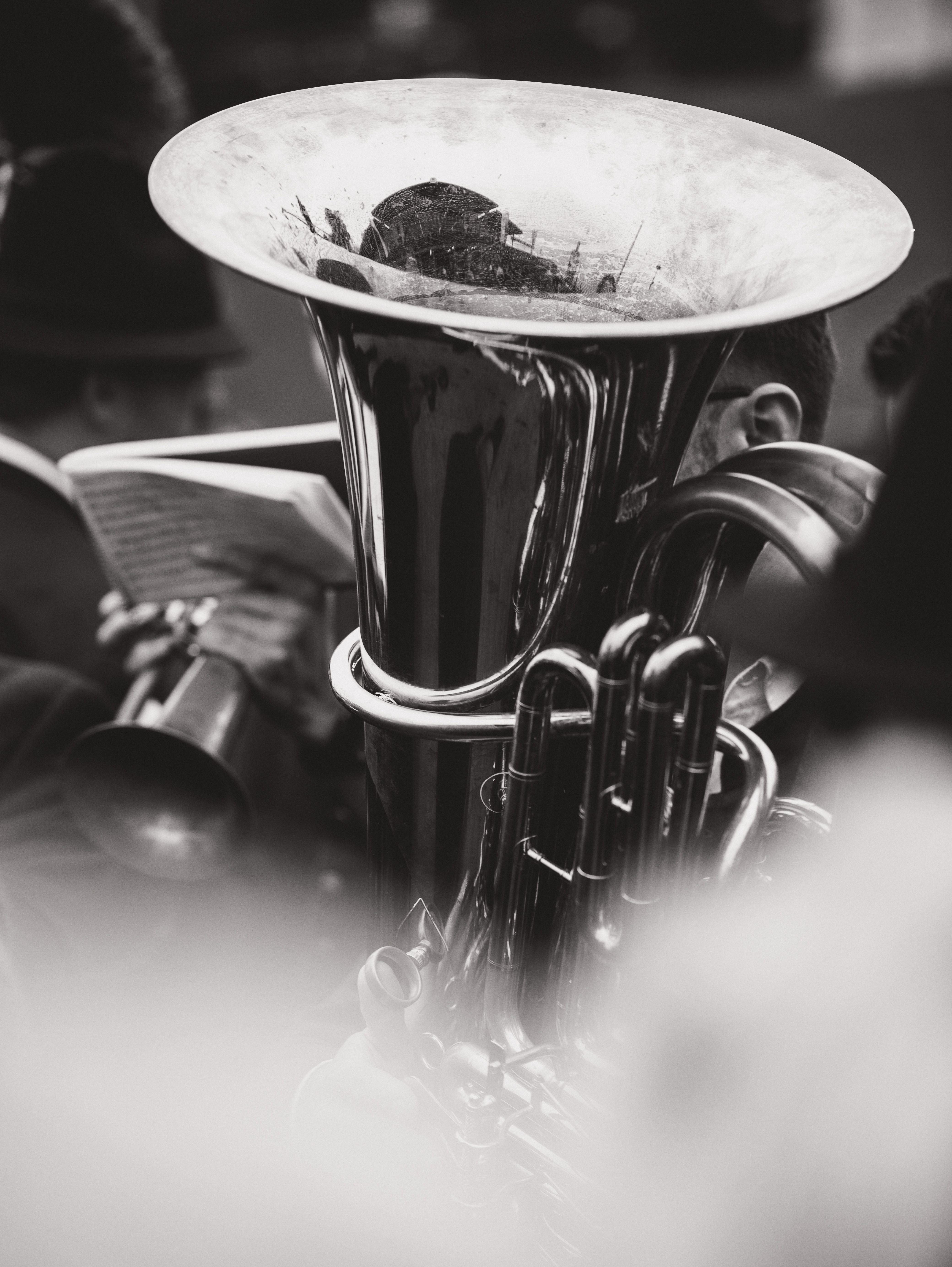 Dramatic black and white image of a brass band player with a tuba in Munich, Germany.