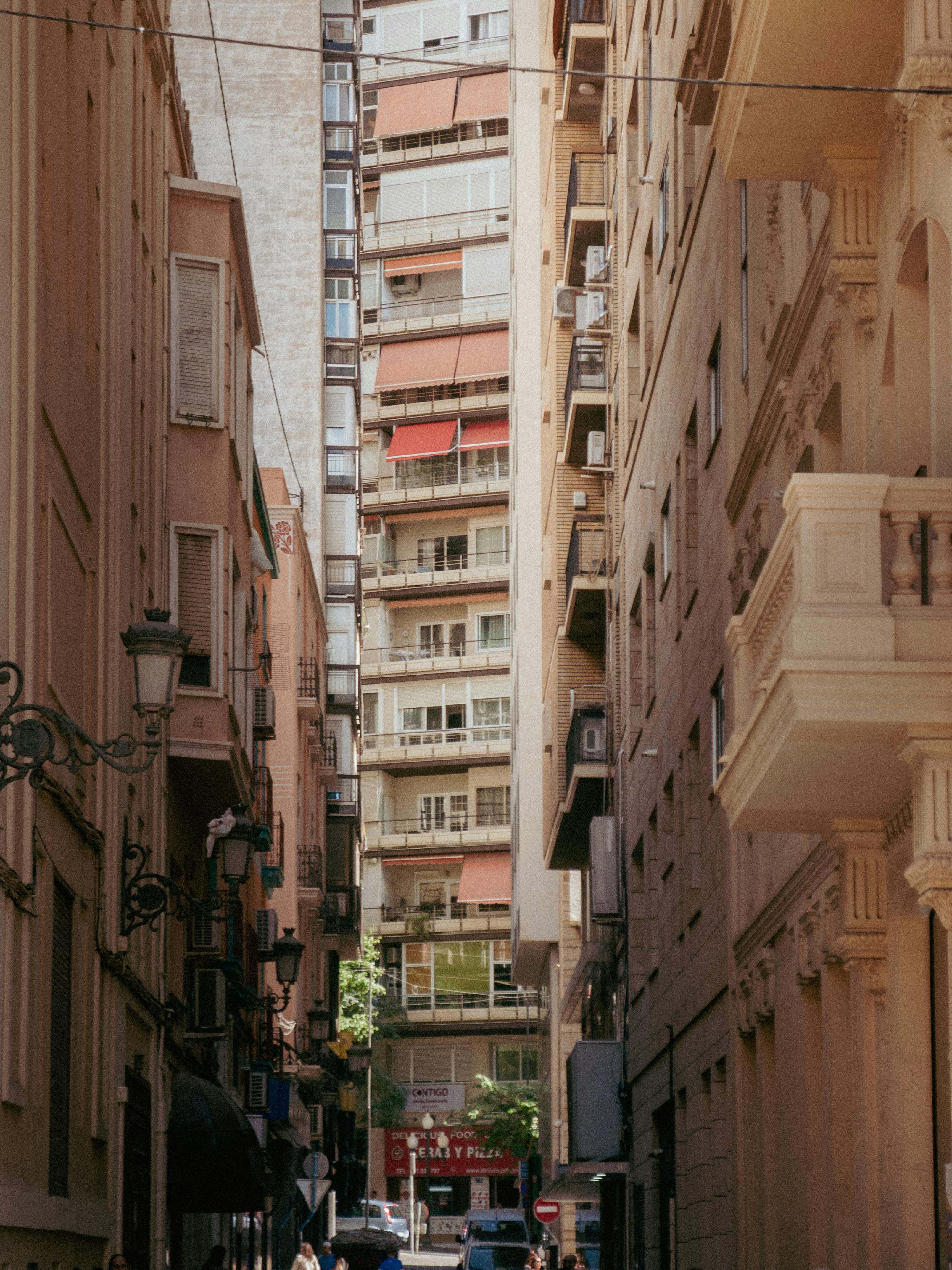 Charming urban alleyway lined with historic buildings under daylight.