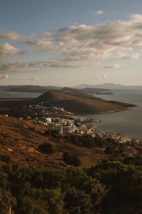 Free A breathtaking aerial view of Sarandë, Albania's coastline at sunset, showcasing natural beauty. Stock Photo