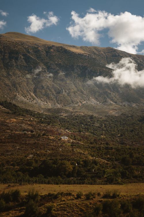 Free Stunning view of mountainous landscape in Gjirokastër, Albania with vibrant clouds. Stock Photo