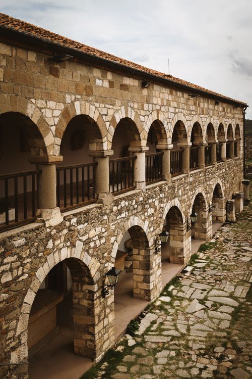 Free Stone arches of a historic monastery in Pojan, Albania, showcasing classic architecture. Stock Photo