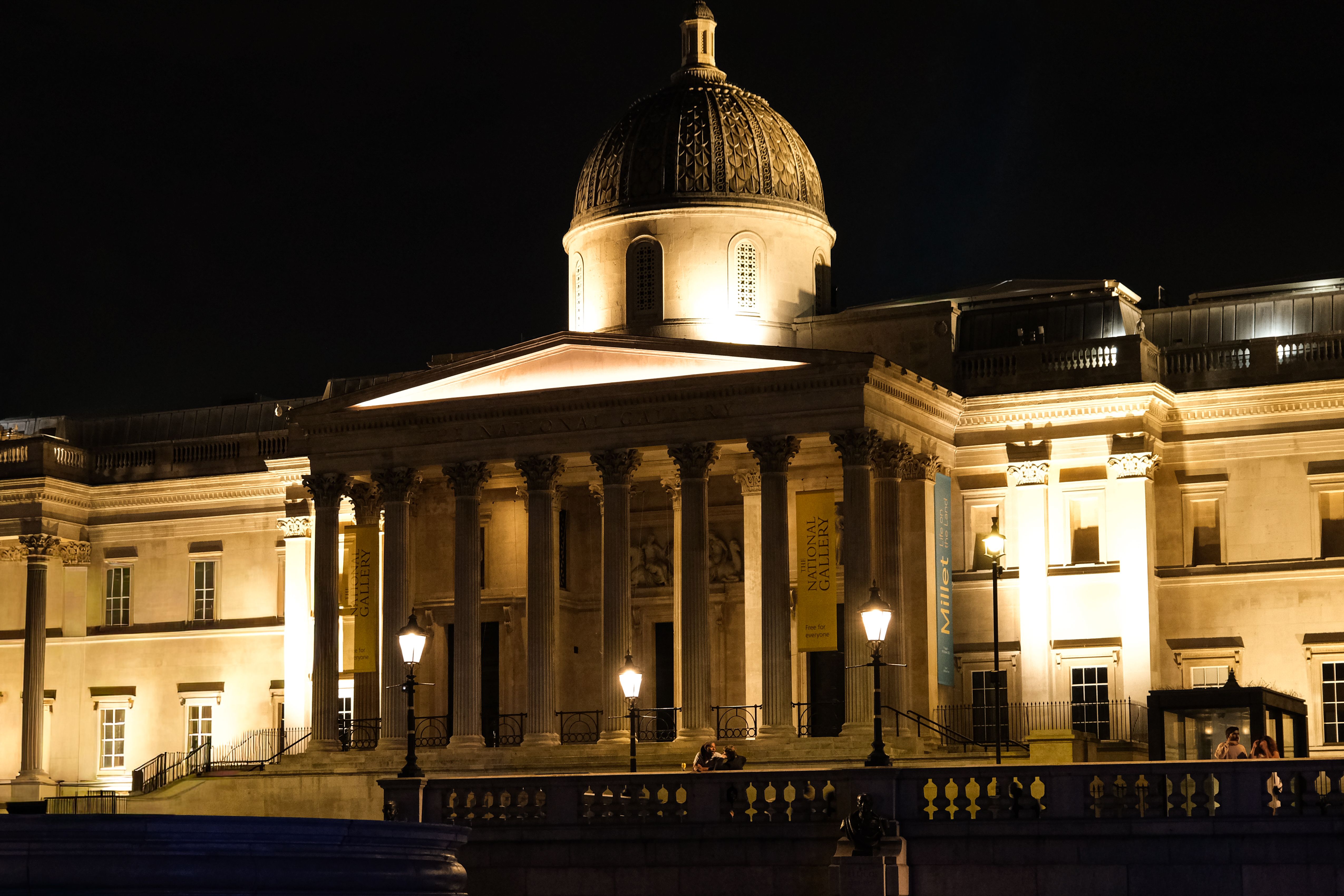 Stunning night view of the National Gallery in London, featuring its classical architecture and warm lights.