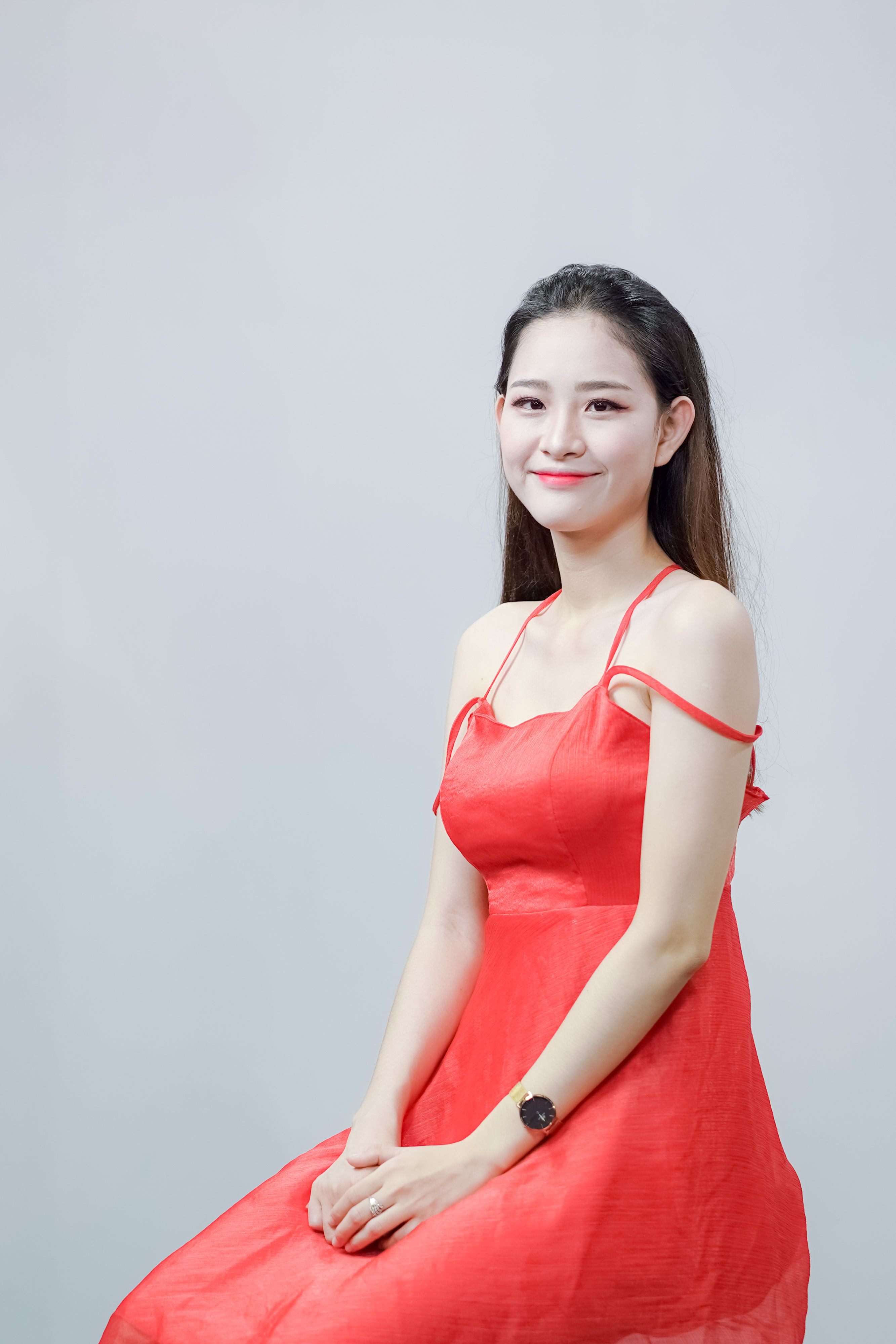 Portrait of a Woman in Red Dress Smiling Indoors · Free Stock Photo