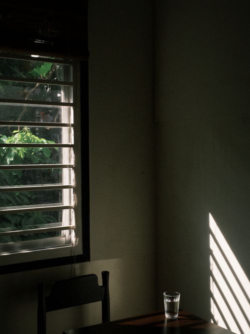 Free Minimalist room with window light casting shadows, creating a peaceful ambiance. Stock Photo