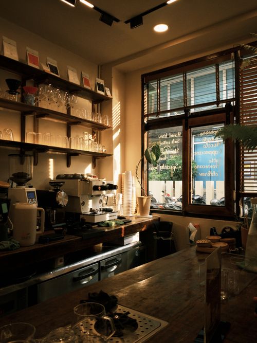 Free Inviting cafe interior featuring espresso machine, counter, and sunlit window. Stock Photo
