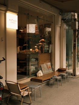 Cozy exterior of a coffee shop with outdoor seating. Warm and inviting atmosphere.