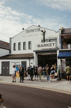 Busy day at Howth Market with visitors enjoying local goods and the vibrant atmosphere.