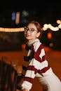 Stylish Woman in Striped Sweater at Night
