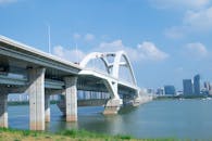 Modern Arch Bridge Over River in Urban Setting
