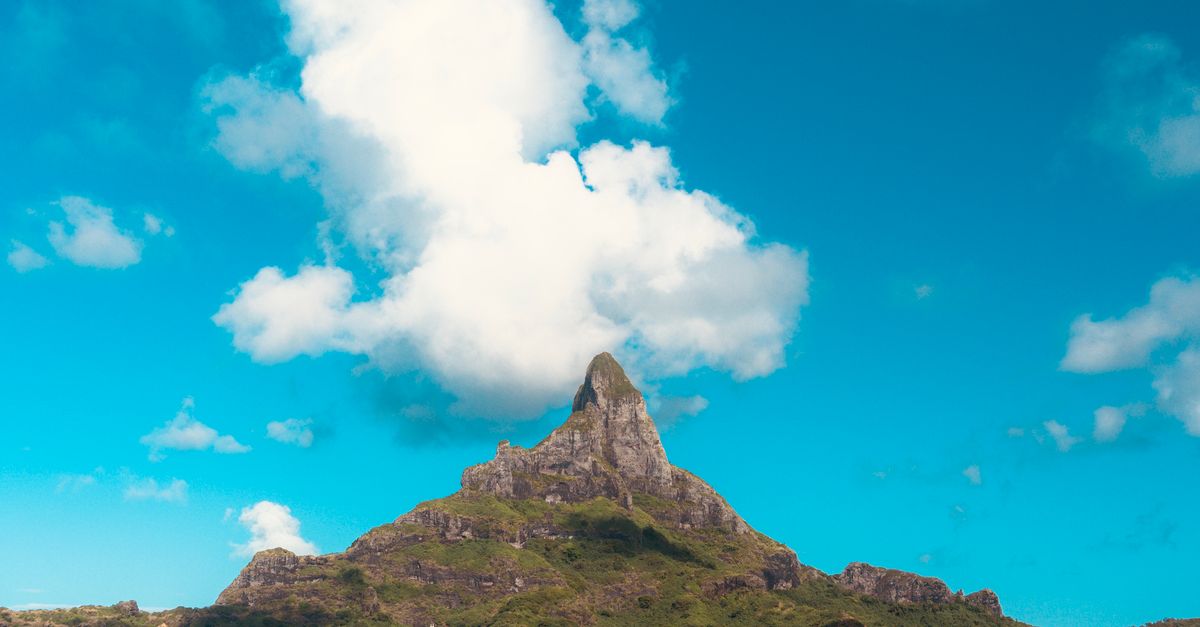 A breathtaking view of Bora-Bora's lagoon with overwater bungalows and mountain backdrop.