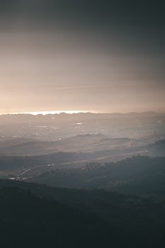 A breathtaking view of mountain ranges with a serene atmosphere during sunrise.