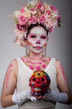 Vibrant Día de Muertos portrait of a woman with Catrina makeup and floral headdress in Mexico City.
