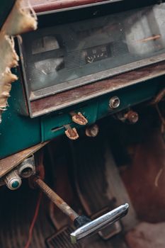 Close-up of a rustic vintage car dashboard with worn-out details, emphasizing a sense of nostalgia and history.