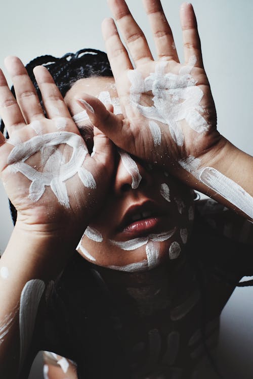 Person Showing Painted Hands and Face