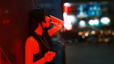 Moody Urban Night Scene with Smoking Woman