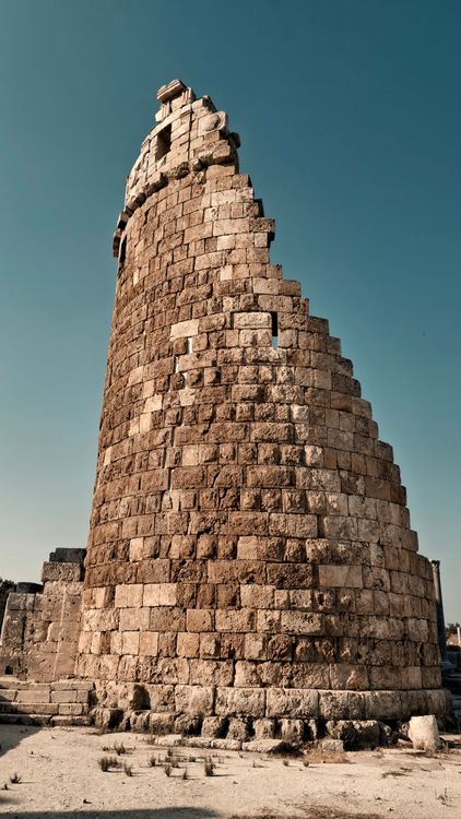 Free Historic stone tower in Antalya, Türkiye showcasing ancient architecture under clear blue skies. Stock Photo