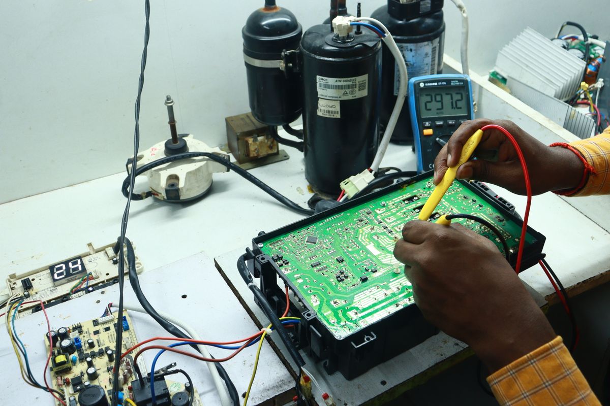Technician inspecting an air conditioning unit for a seasonal maintenance guide