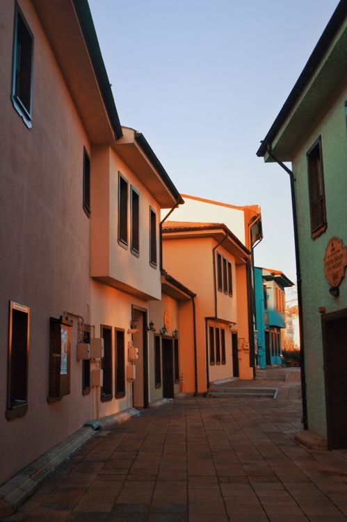 Free Explore the vibrant and colorful architecture of Eskişehir's charming alleyway, basking in the warm evening light. Stock Photo