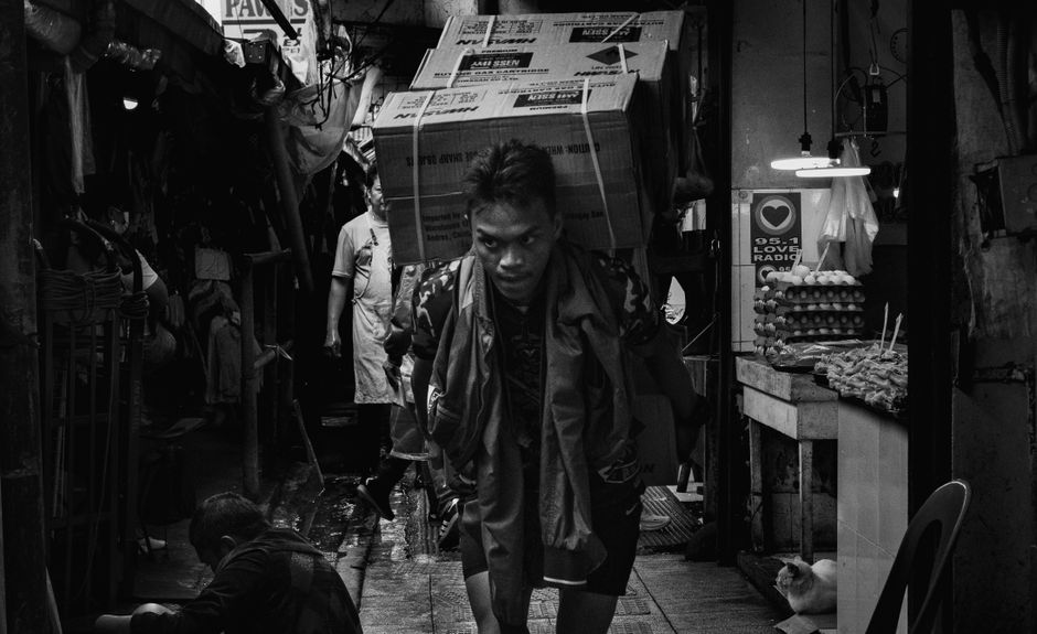 A black and white scene of market laborers in Baguio City, showcasing daily life and hard work.