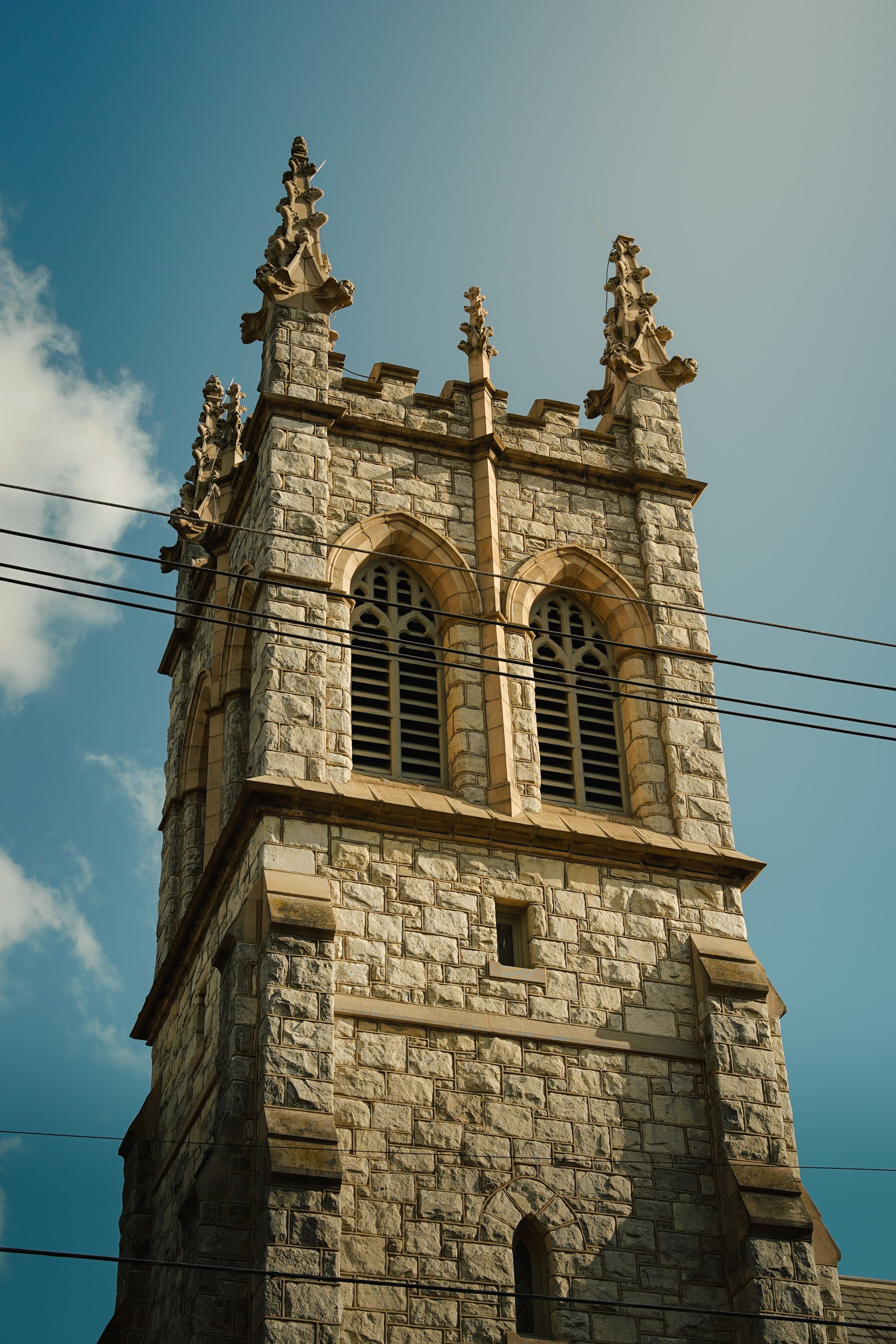 Historic Stone Church Tower Against Blue Sky · Free Stock Photo