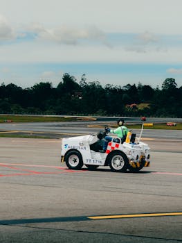 Airport tug vehicle on open tarmac at Rionegro, Antioquia, Colombia, clear sky backdrop.