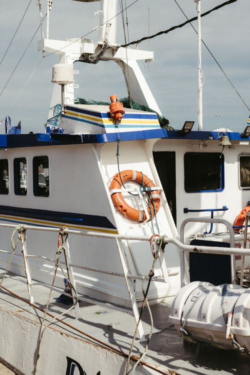 Free A fishing boat docked in Dublin Harbor under clear skies, showcasing maritime details. Stock Photo