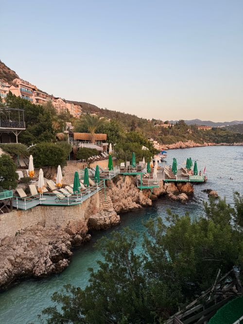 Free Beautiful coastal terrace overlooking clear blue waters under a pastel sky at dusk. Stock Photo