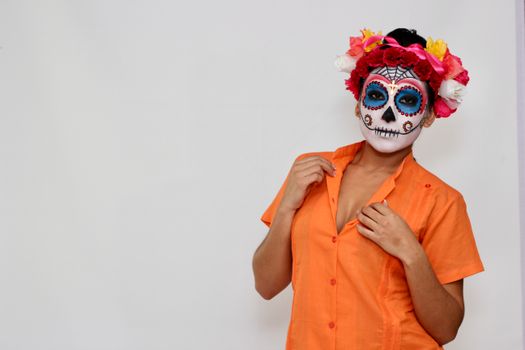 Vibrant Day of the Dead makeup with floral headpiece, capturing cultural celebration.