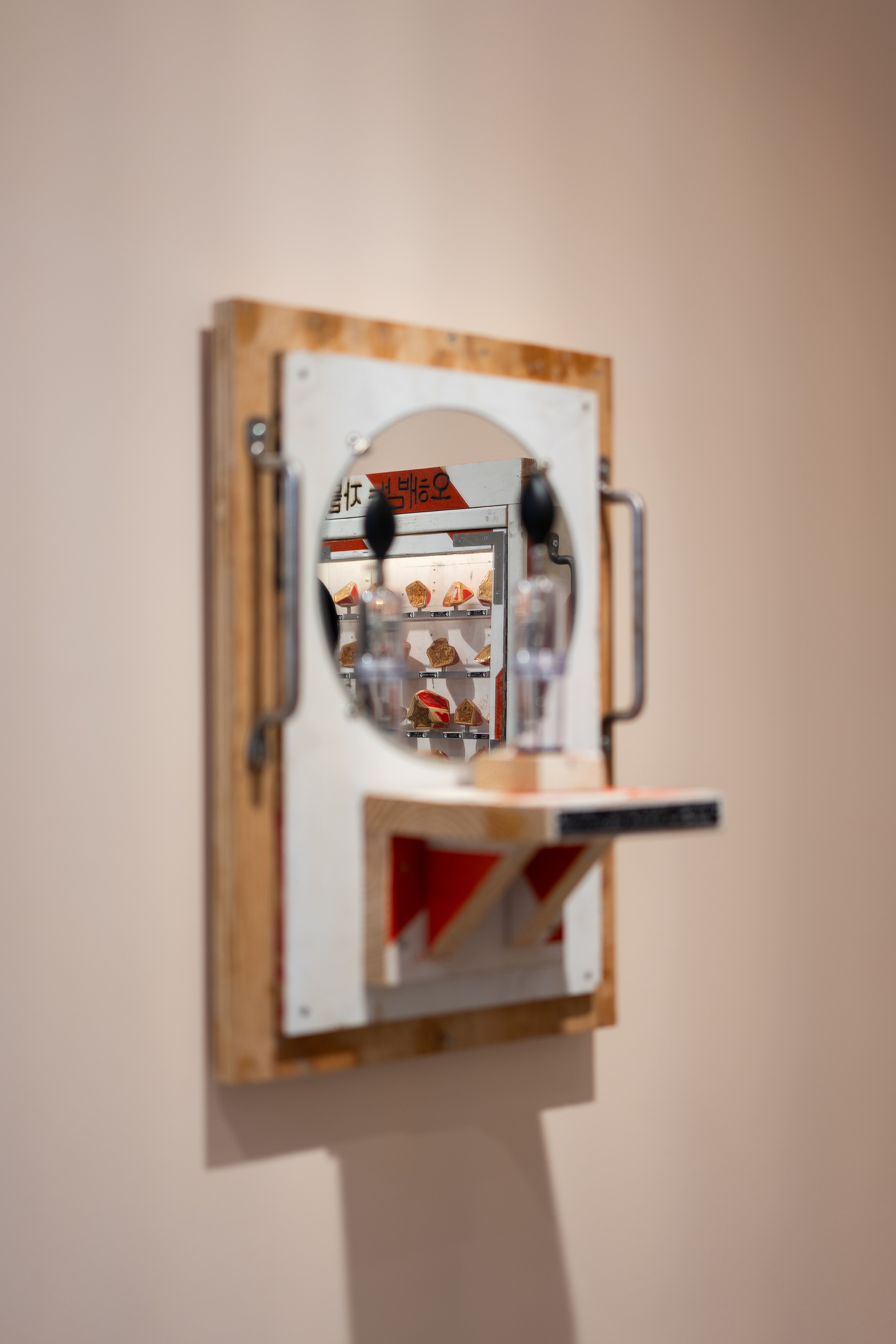 Artistic photo of a wall-mounted mirror with a museum reflection.