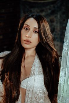 Stunning portrait of a woman wearing a lace shawl, exuding grace and elegance.