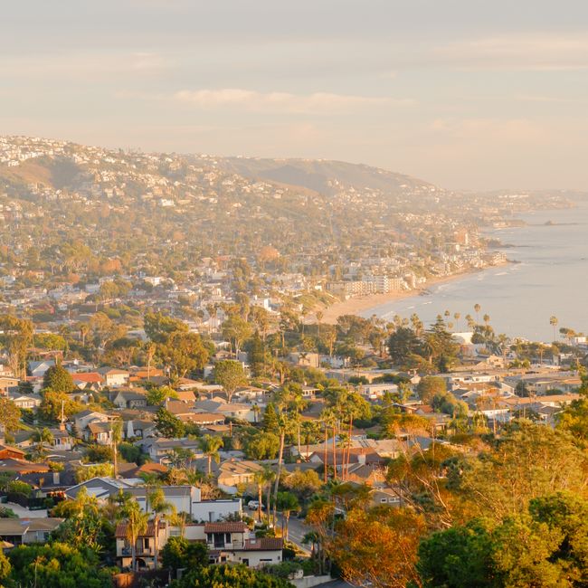 A picturesque aerial view of Laguna Beach, California, capturing the coastal landscape at sunset.