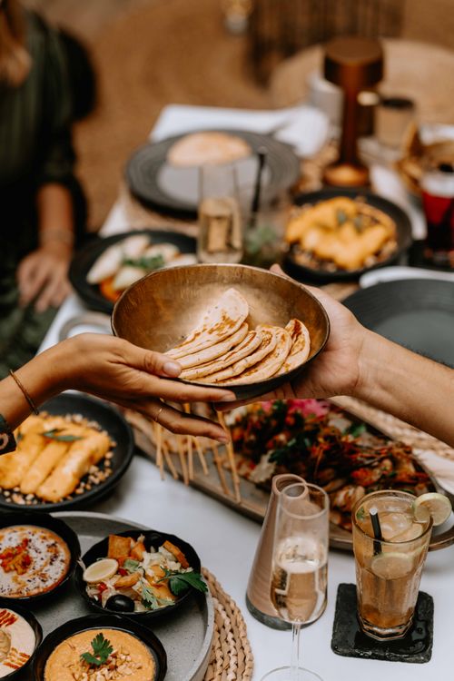 Free A lavish spread of exotic dishes on a beautifully set dining table, capturing a luxurious dining experience. Stock Photo