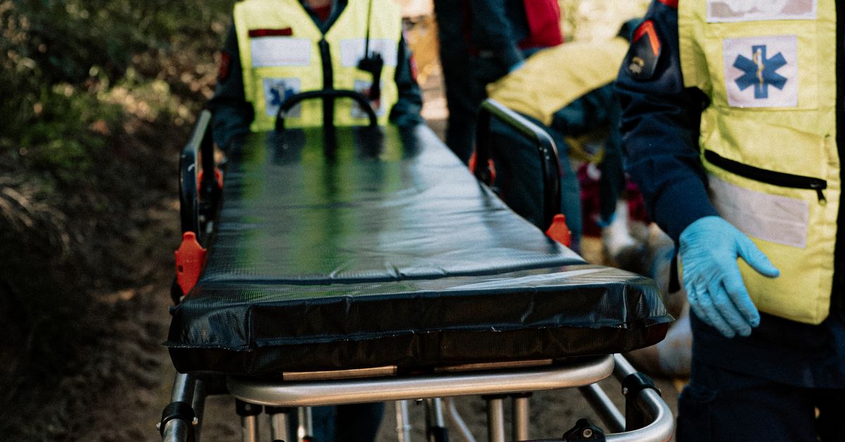 Photo by Aleson Padilha Emergency responders navigate outdoors with a stretcher during a simulation exercise.