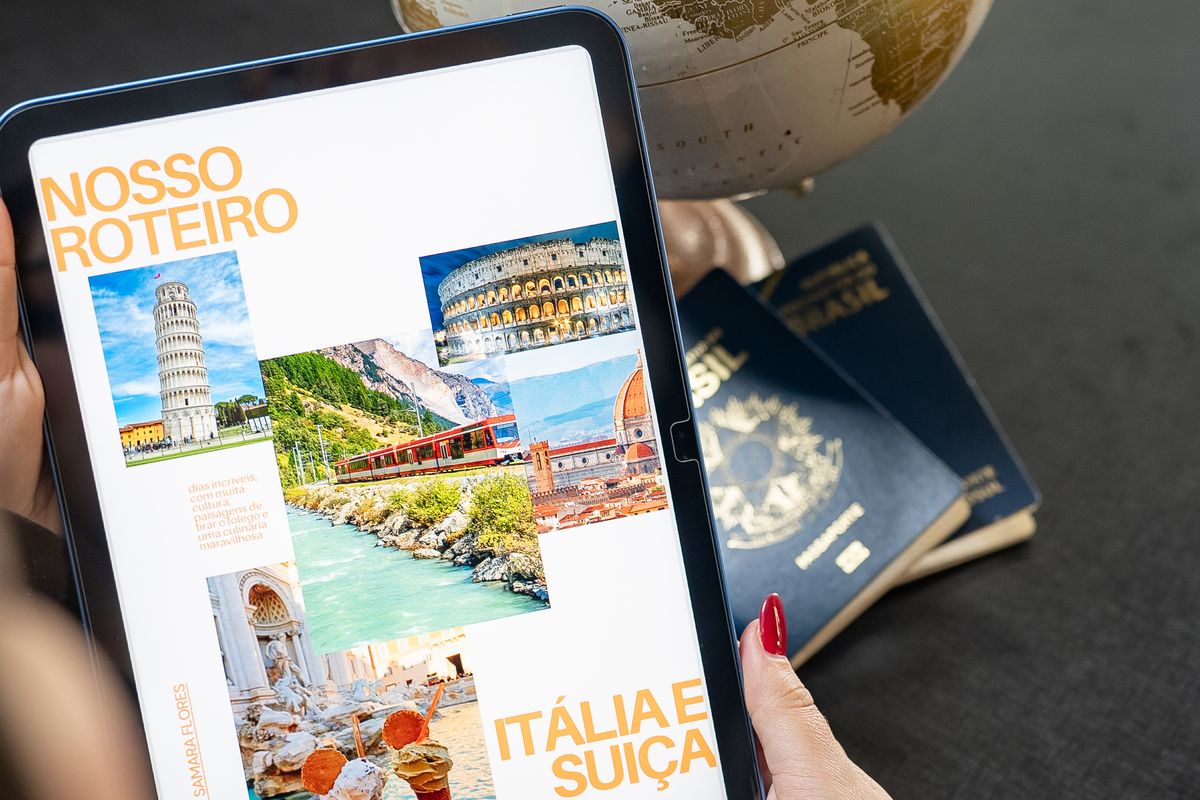 Traveller planning a route on a tablet with passports on the table