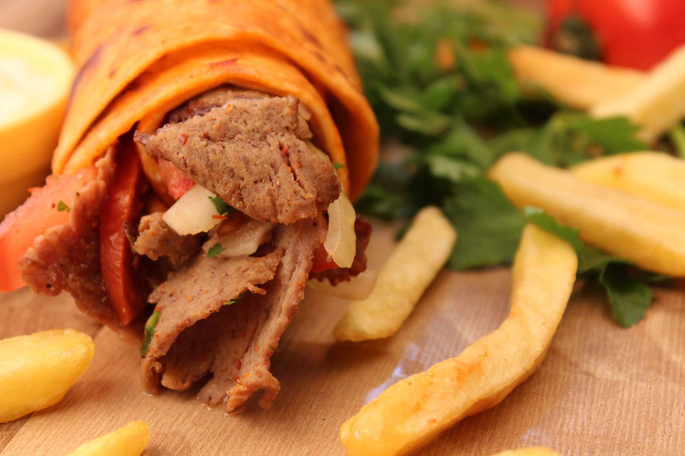 Delicious Doner Kebab with Fries on Wooden Table · Free Stock Photo