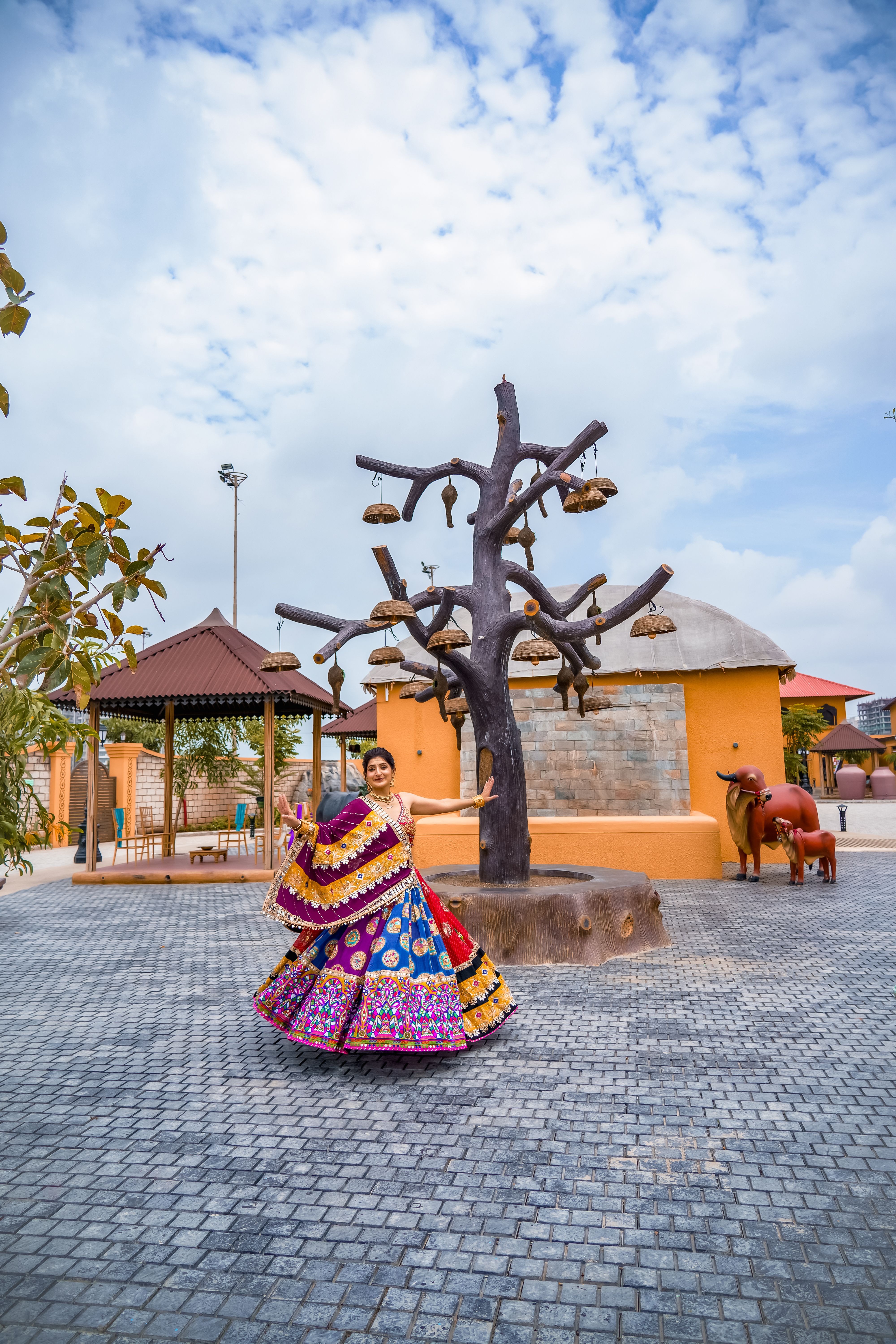 Vibrant traditional Indian dancer in cultural attire performing in a scenic outdoor setting.