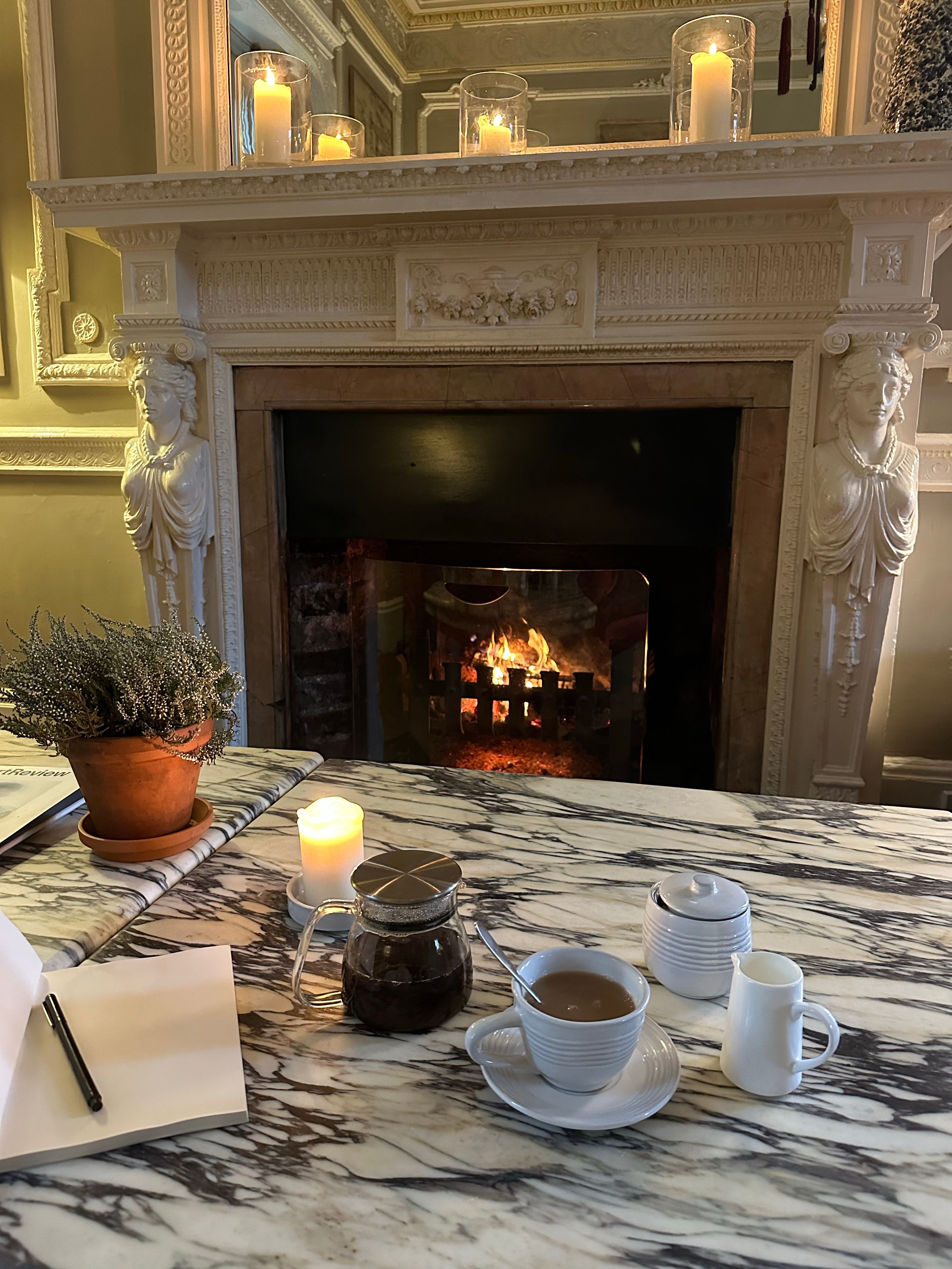 Cozy Indoor Scene with Fireplace and Coffee · Free Stock Photo
