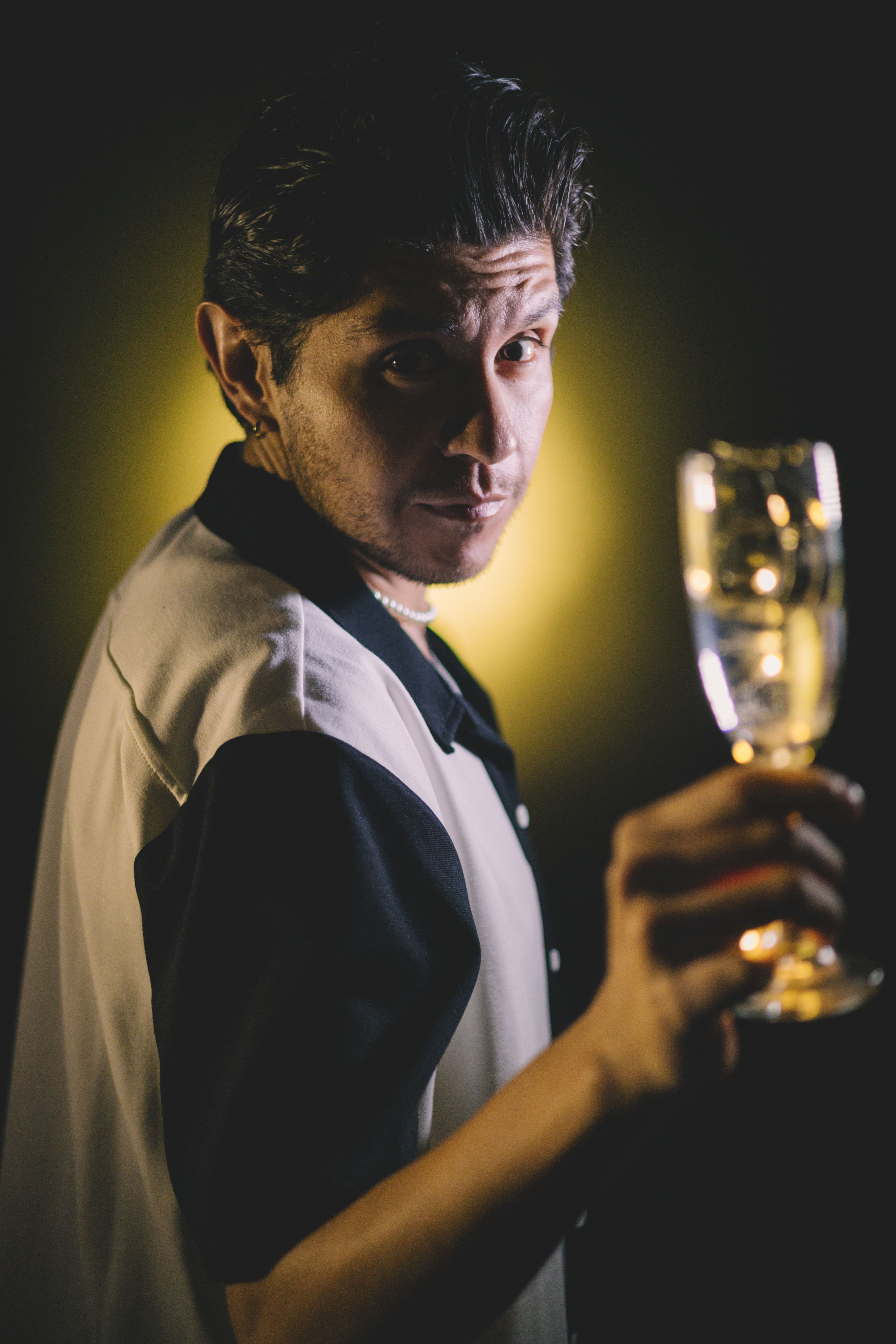 Chic gentleman toasting with a wine glass, capturing a moment of celebration.