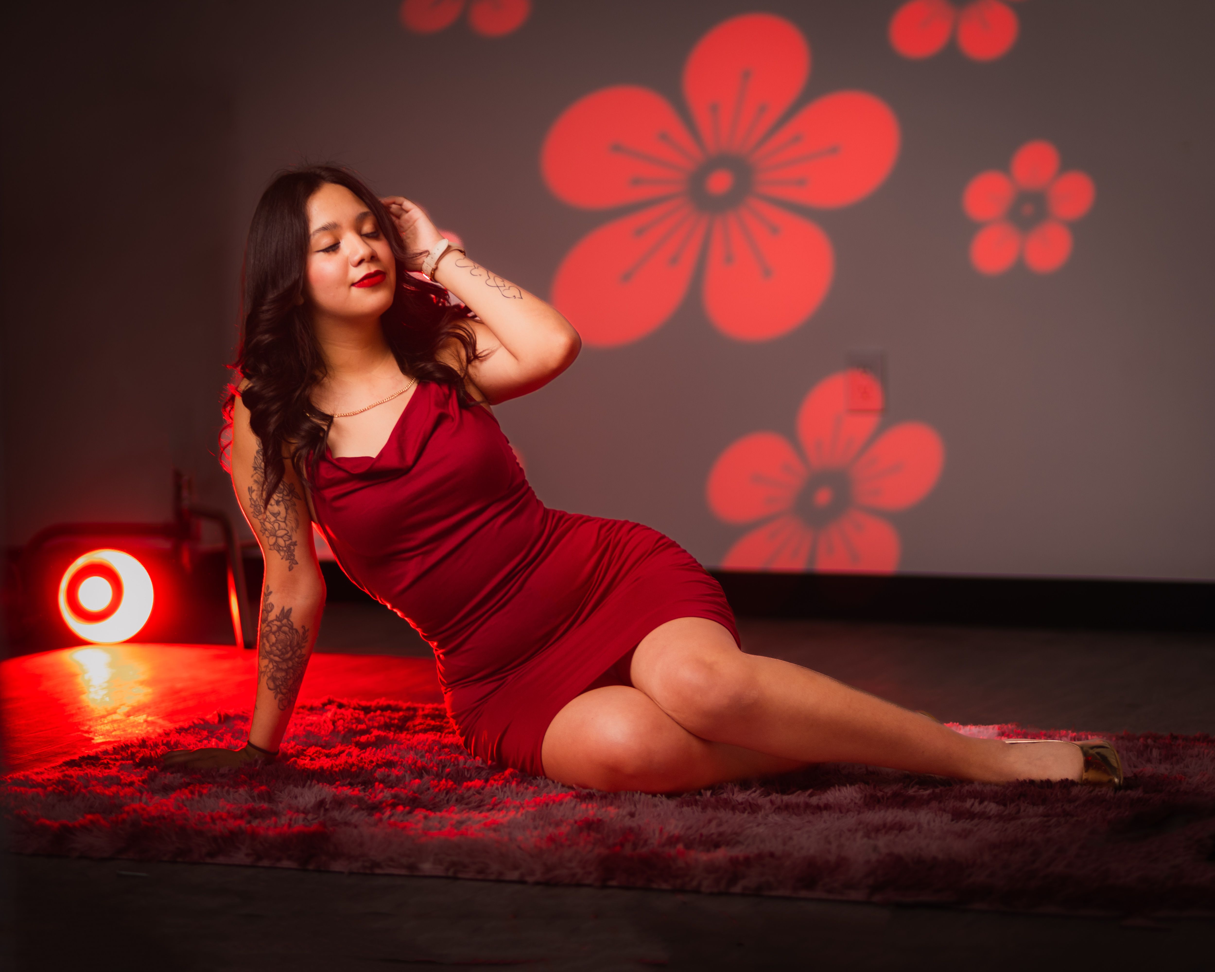 Elegant Woman in Red Dress with Floral Background · Free Stock Photo