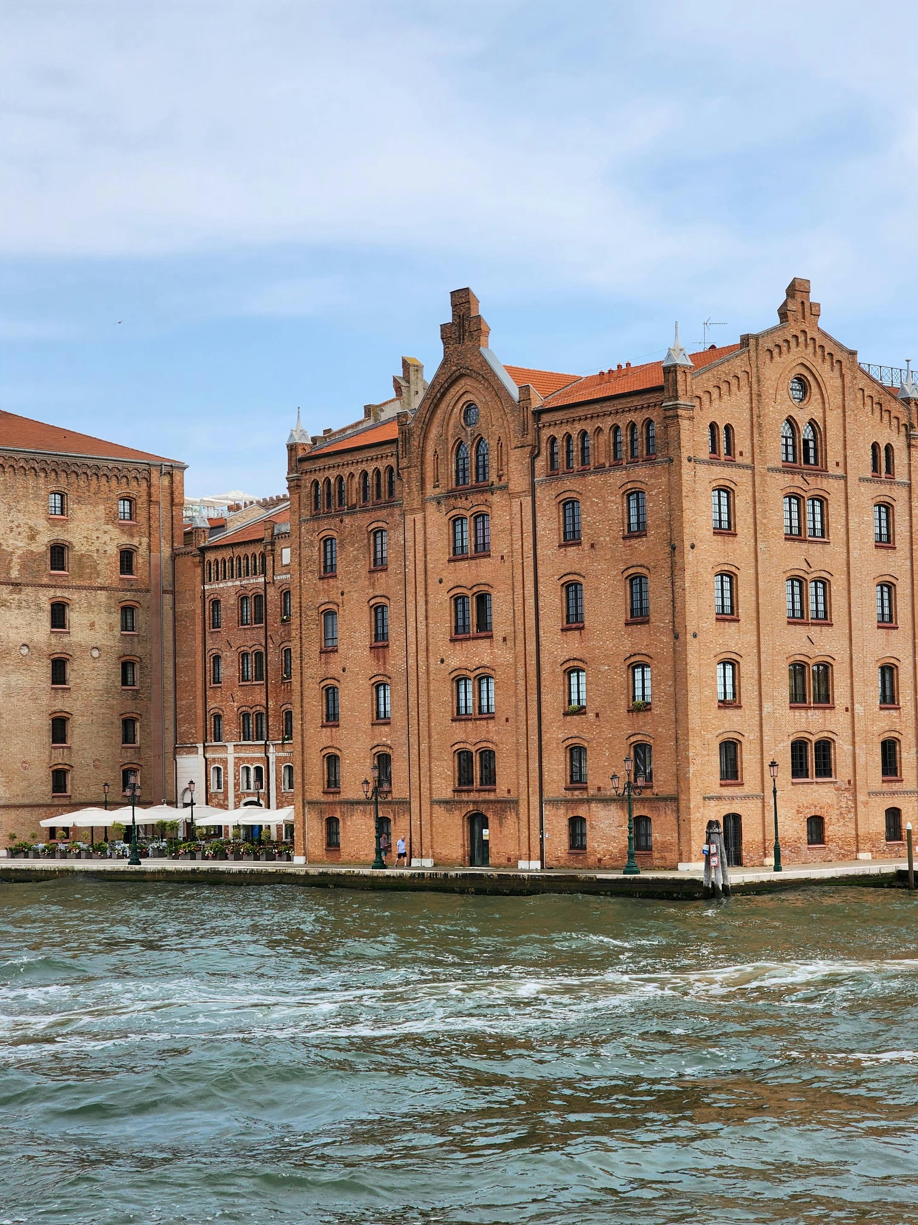 Charming red brick waterfront buildings in a picturesque European city.