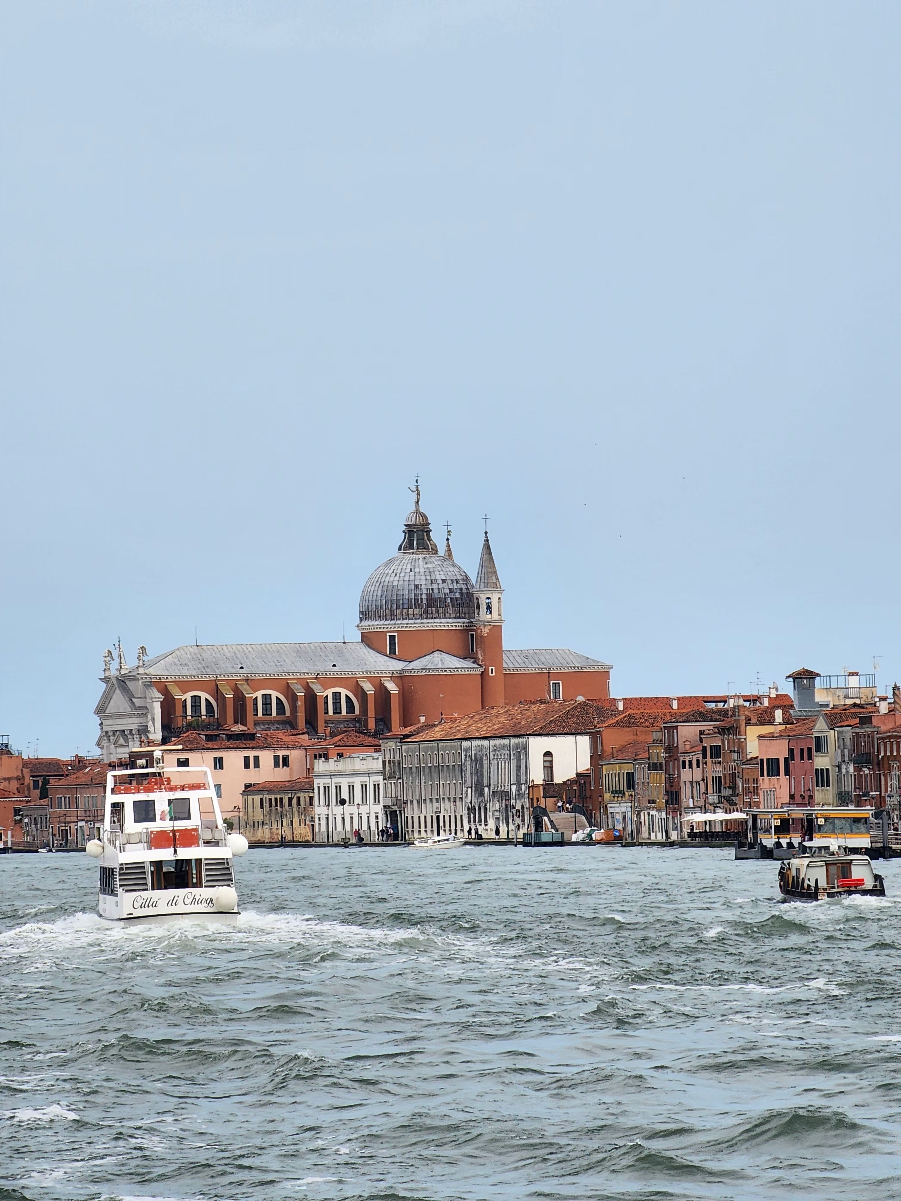 Charming view of Venice's canals with boats and historical architecture in daylight.