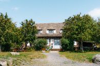 Quaint rural house surrounded by lush greenery in Auvergne-Rhône-Alpes, France.
