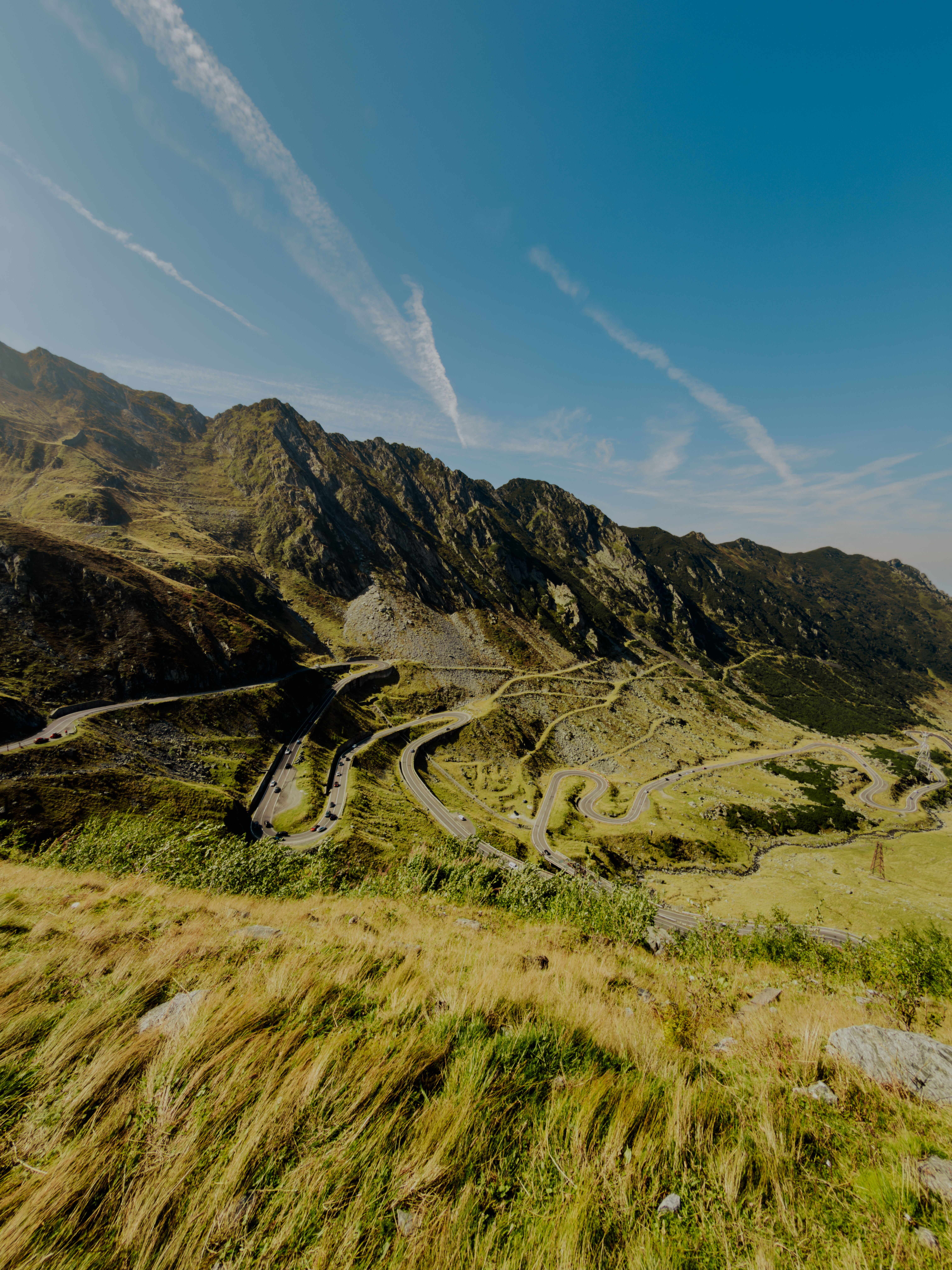 Winding roads of Transfagarasan Highway amid Romania's stunning Carpathian Mountains landscape.