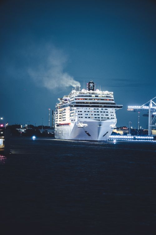 Free Large cruise ship gracefully sailing at night in a busy harbor. Stock Photo