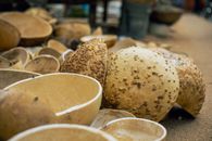 Detailed view of dried calabash gourds arranged in an outdoor market setting.