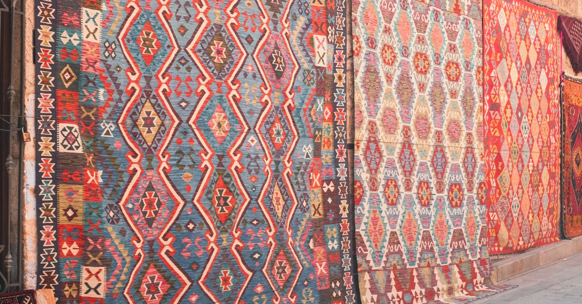 Traditional Rug Textile Vibrant Traditional Rugs on Display Outdoors · Free Stock Photo